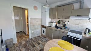 a small kitchen with a table and a yellow stool at Luna in Osijek