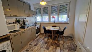 a small kitchen with a small table and chairs at Luna in Osijek +10 photos