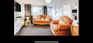 a living room with two chairs and a couch at Kingfisher Holiday Park 1 Waveney Valley Great Yarmouth in Gorleston-on-Sea