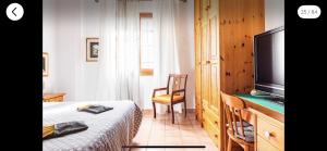 a bedroom with a bed and a flat screen tv at B&B Colle Paradiso in Cesena