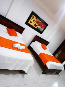 Postel nebo postele na pokoji v ubytování Hotel El Bosque Valledupar