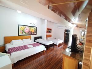 Postel nebo postele na pokoji v ubytování Hotel El Bosque Valledupar
