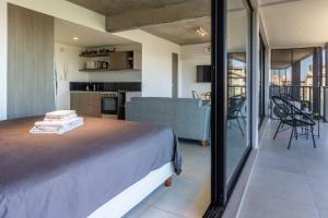 a bedroom with a bed and a view of a kitchen at Loft Elegante a 5 Minutos de Puerto Madero 6B in Buenos Aires +37 photos