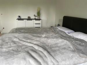 Appartment Königshof في كريفيلد: غرفة نوم مع بطانية كبيرة على سرير