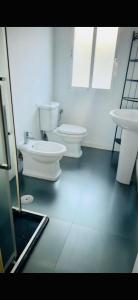 a bathroom with two toilets and a sink at Piso reformado en Murcia con terraza in Murcia