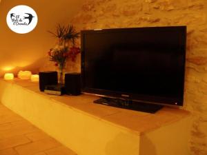 a flat screen tv sitting on a counter with speakers at El Pati de L´Oroneta in Els Ibarsos