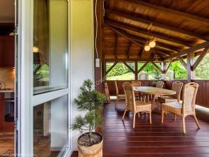 a patio with a table and chairs on a porch at Polna Zagroda - domek do wynajęcia in Kielce