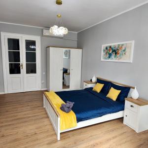 a bedroom with a bed with a teddy bear sitting on it at City Center apartment -A in Cluj-Napoca +6 photos