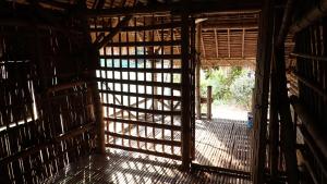 porta aperta a una camera con pavimento in legno di OBT - The Longan Bungalow 