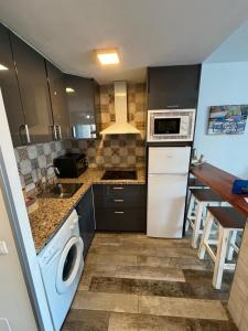 a kitchen with a washer and a sink and a dishwasher at Benal Beach 907 in Benalmádena