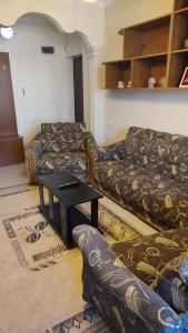 a living room with a couch and a table at Gigi Apartments in Batumi