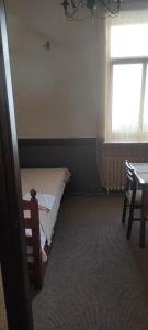 a small bedroom with a bed and a window at Hostel Lux in Kaunas