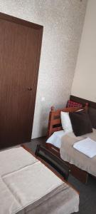 a bedroom with two beds and a door at Hostel Lux in Kaunas