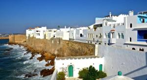 a group of white buildings and the ocean at Bel Appart Marina Golf Asilah in Asilah