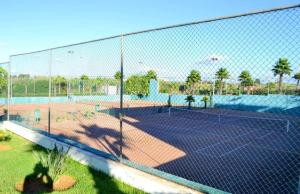 a tennis court with a net on a tennis court at Bel Appart Marina Golf Asilah in Asilah
