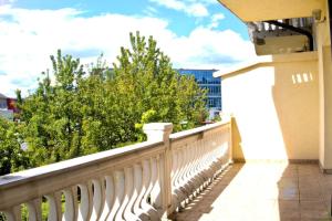 a balcony with a white railing and trees at Sarajevo Sky Suite in Sarajevo