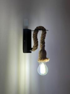 a light with a cat tail hanging from a lightswitch at Casa La Muga in Benasque
