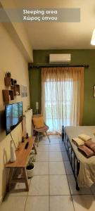 - une chambre avec un lit, une table et une télévision dans l'établissement Efi Studio 4 Lamia, à Lamía