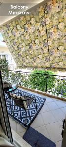 a balcony with a chair and a wall of flowers at Efi Studio 3 Lamia in Lamía