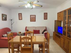 a living room with a table and a couch at CH Apartamentos Luque in Luque