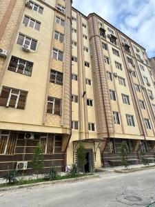a large apartment building on the side of a street at Bonushka 5 in Uzbankinty