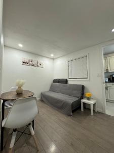 a living room with a bed and a table at Guest House in West Covina