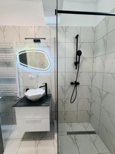 a bathroom with a glass shower with a sink at RRed in Năvodari +4 photos