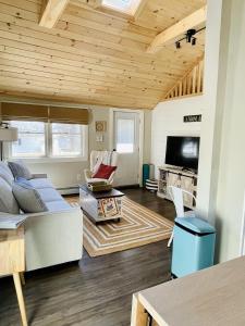 a living room with a couch and a tv at Pet Friendly 2 BR House in Southwest Harbor! [Hillside Cottage] in Southwest Harbor