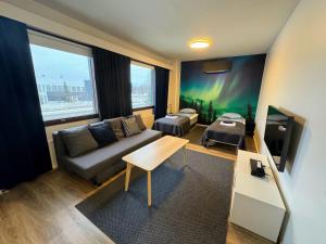 a living room with a couch and a table at Pine Sky Apartments in Ivalo
