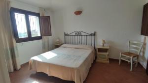 Кровать или кровати в номере Villa Pidda a San Teodoro