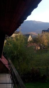 a balcony of a house with a view of a field at Chata Pod Kwiatkiem in Zawoja