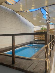 a swimming pool with a net on a wooden deck at Terra Petra in Sfakaki