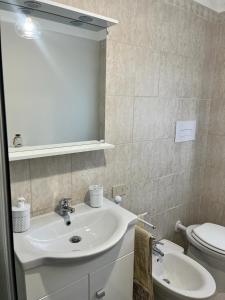 a bathroom with a sink and a toilet at Casa Zezza2 in Zapponeta