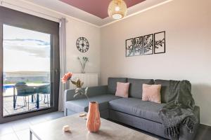 a living room with a couch and a table at Iliovasilema Luxury Apartment in Heraklio Town