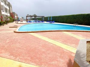 a large swimming pool in a building with at Cecelia Hotel Suites Hurghada in Hurghada