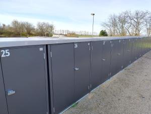 a row of gray lockers on the side of a building at Ostseegolf - Ferienappartement in Hohen Wieschendorf