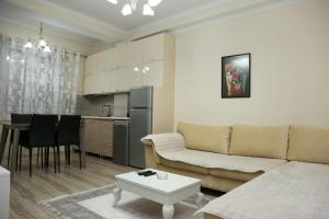 a living room with a couch and a table at Ergi’s Host Apartment in Tirana