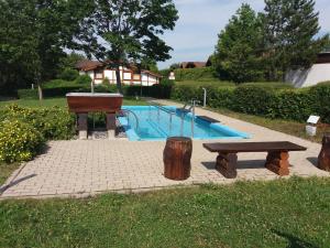 ein Picknicktisch und ein Klavier neben einem Pool in der Unterkunft Villa Leni im Schwarzwald in Bad Dürrheim