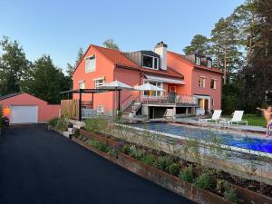 une maison avec une piscine en face de celle-ci dans l'établissement Lidingö, à Lidingö