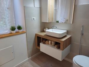 a bathroom with a sink and a toilet at Dentro le Mura-Suite House in Sassari +15 photos