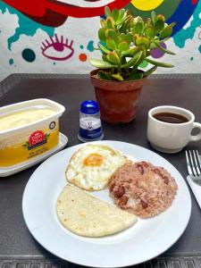 a plate of food with eggs and meat on a table at Rock Hostel Medellin in Medellín