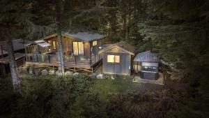 a large wooden house in the middle of a forest at The Great Escape - Port Renfrew in Port Renfrew