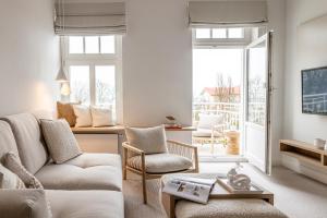 a living room with a couch and two chairs at Villa Astoria - Kühlungsborn in Kühlungsborn