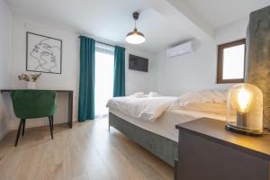 a bedroom with a bed and a desk and a chair at Villa Fran, Krk in Sveti Vid-Miholjice +29 photos