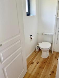 a bathroom with a toilet and a door at Appartements du 101 in Villeneuve d'Ascq