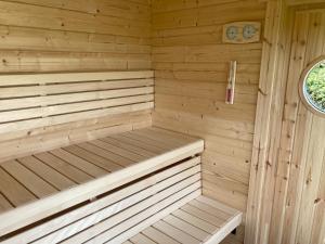 a wooden sauna with two benches in it at Corner House in Cudworth