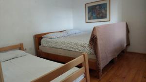 a bedroom with two beds and a picture on the wall at Kuća za odmor Arija in Novi Vinodolski