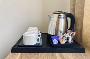 a black tray with a coffee maker and a coffee mug at Sattal Valley Resort in Bhīm Tāl