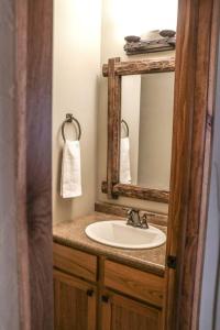 a bathroom with a sink and a mirror at Bearskin Peninsula in Hazelhurst