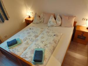 a bedroom with a bed with white sheets and pillows at Nassfeld and Lake Apartment in Hermagor